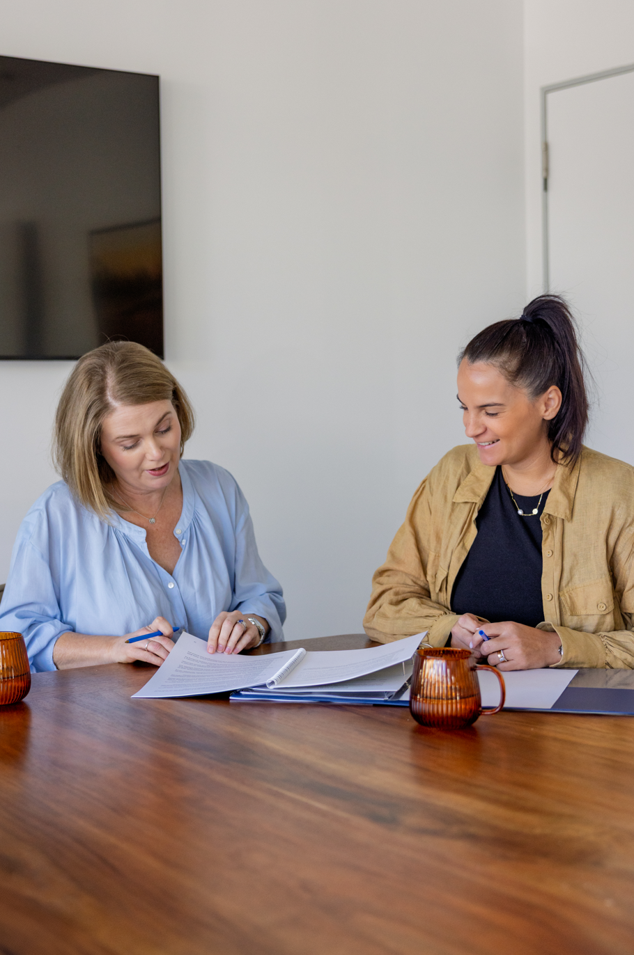 Two Wakefield Pacific advisors reviewing a client strategy document together