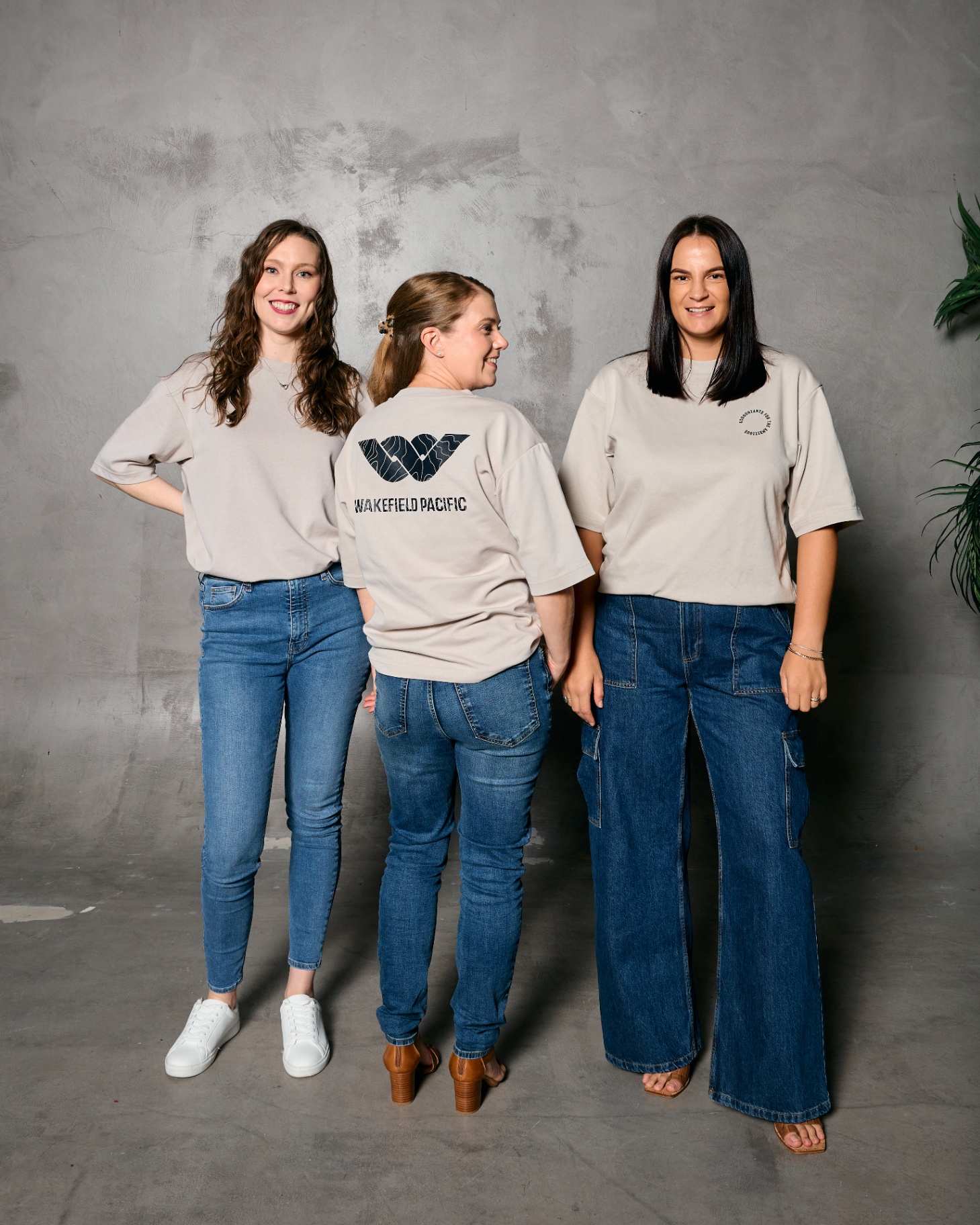 Three Wakefield Pacific team members in branded Accountants for the Ambitious™ tees