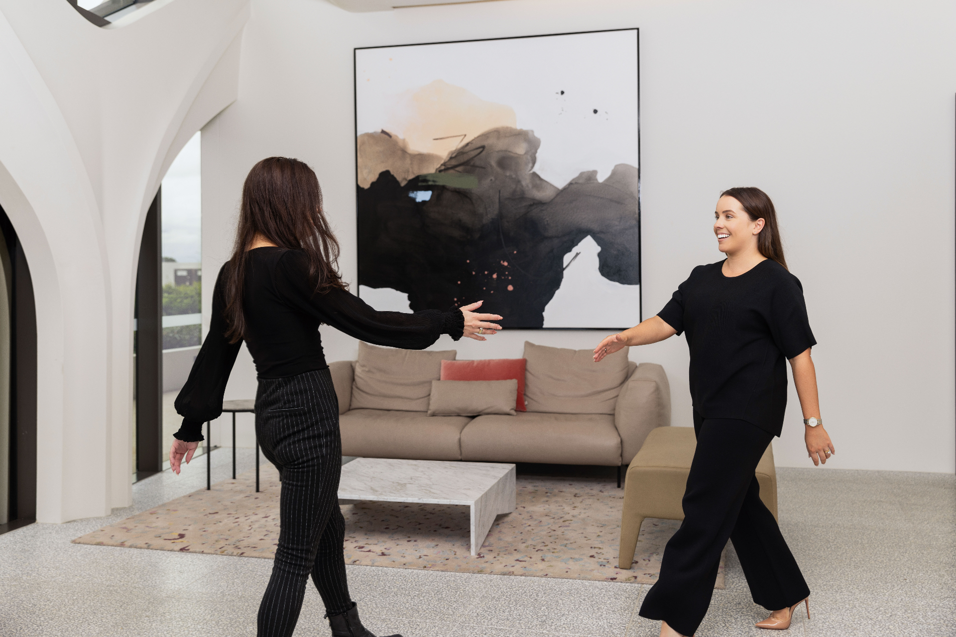 Two team members greeting a client at the Mermaid Beach office